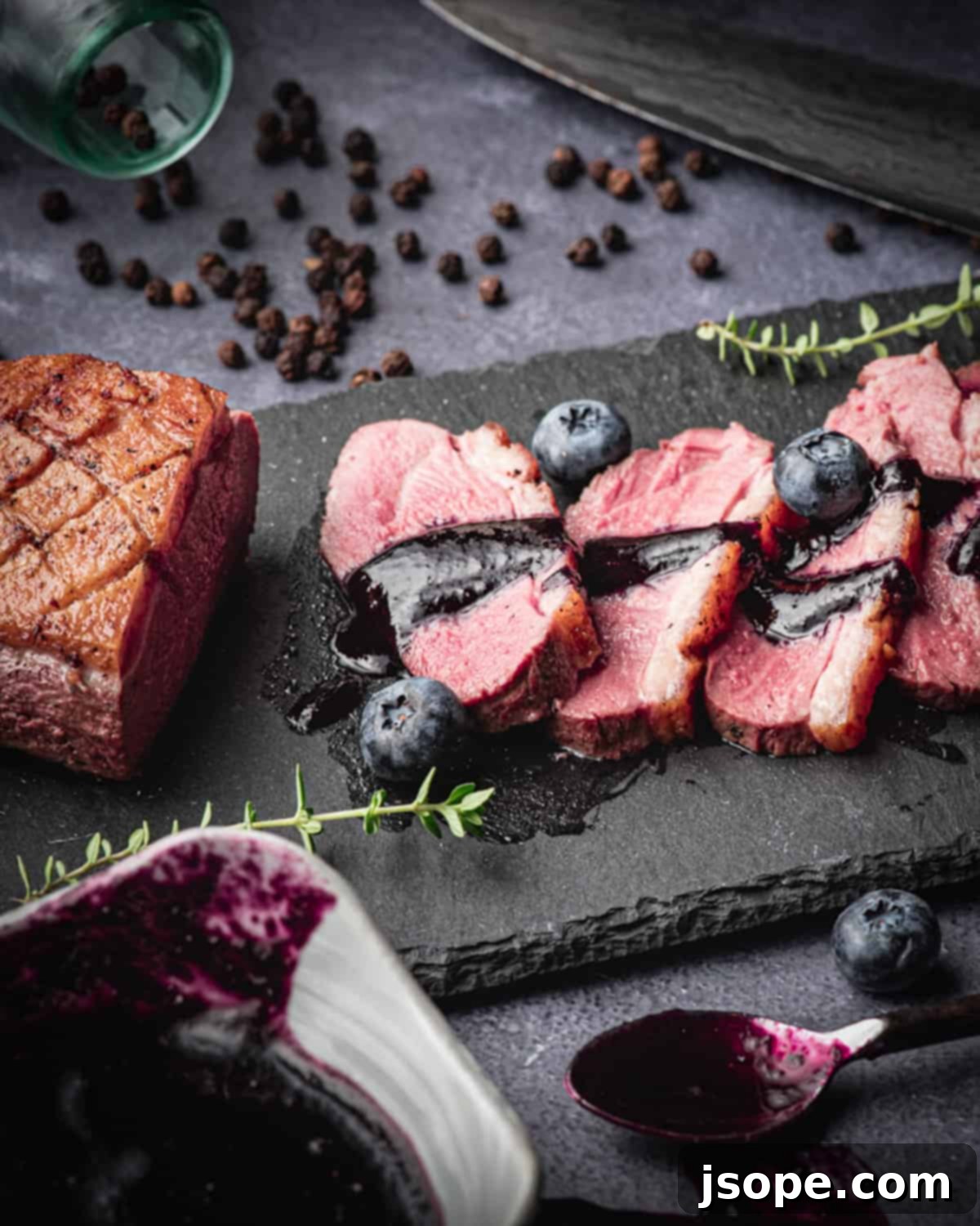 Blueberry Thyme Red Wine Reduction in a small pot, showcasing its rich, deep color.