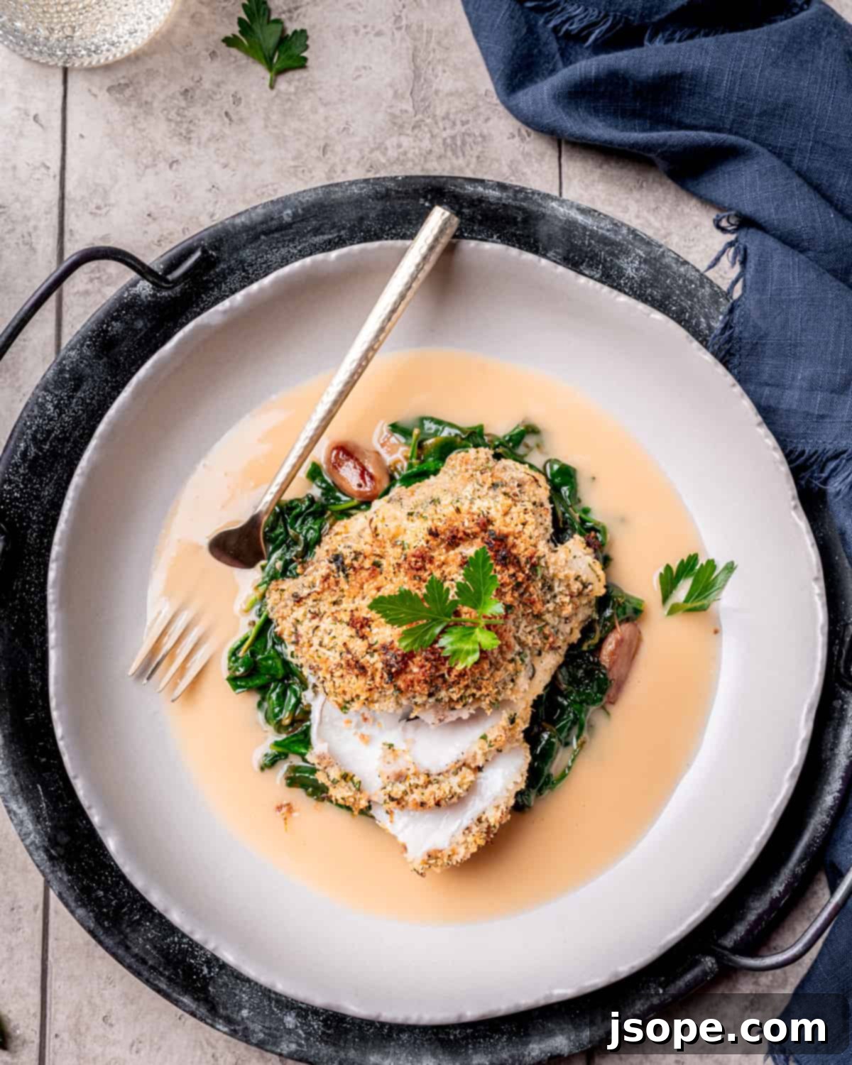 Crispy Parmesan Crusted Baked Cod served with lemon and herbs.