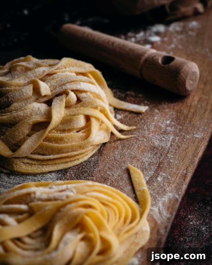 Freshly made Homemade Pasta Dough resting on a wooden board, ready to be prepared