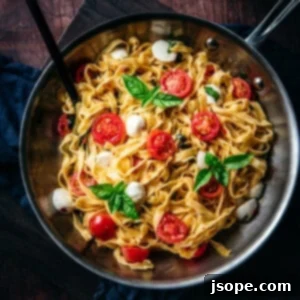 Summer Pasta (Pasta d'estate) with fresh ingredients, garnished with basil and mozzarella