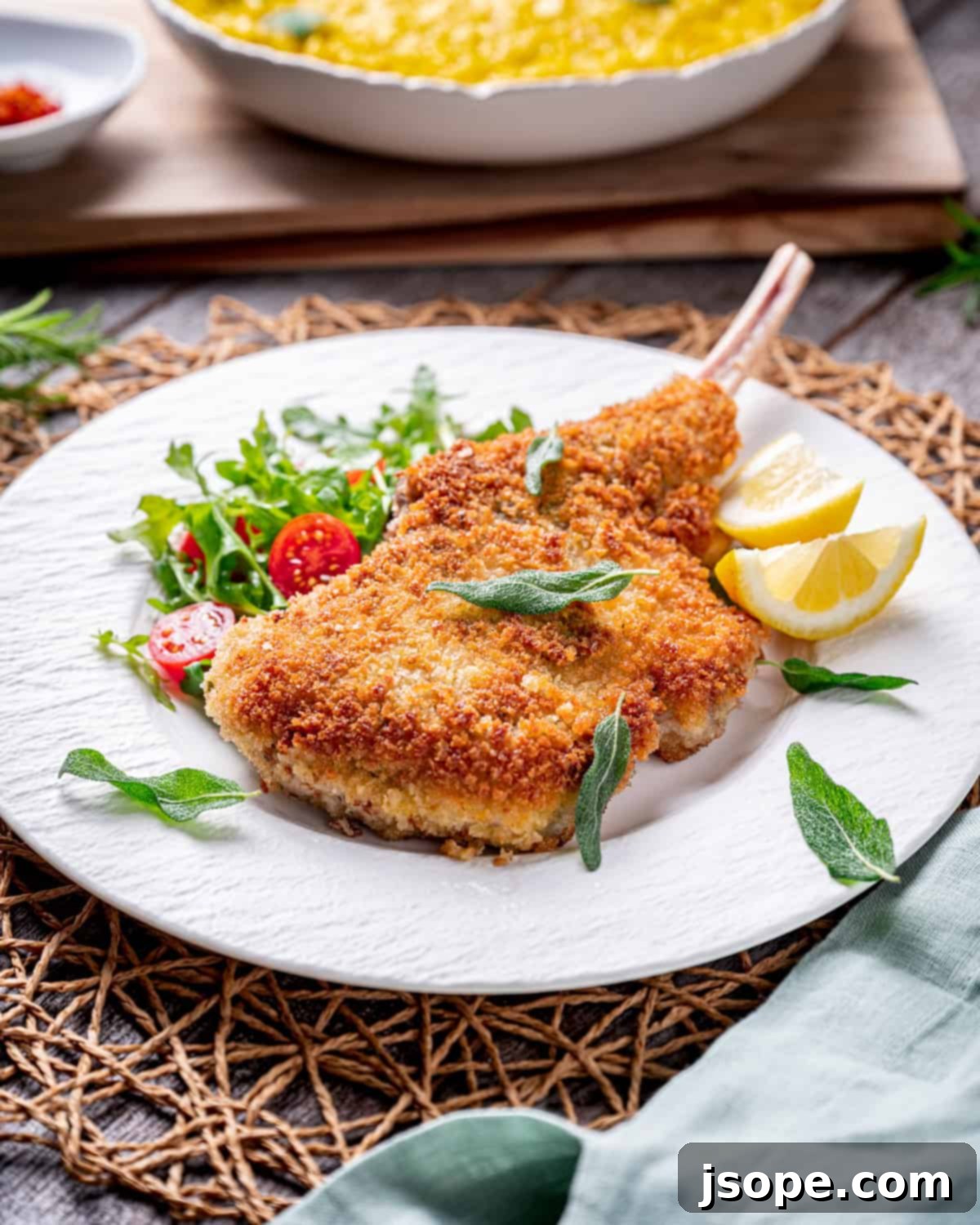 A close-up shot of the perfectly golden brown and crispy crust of Bone-In Veal Milanese