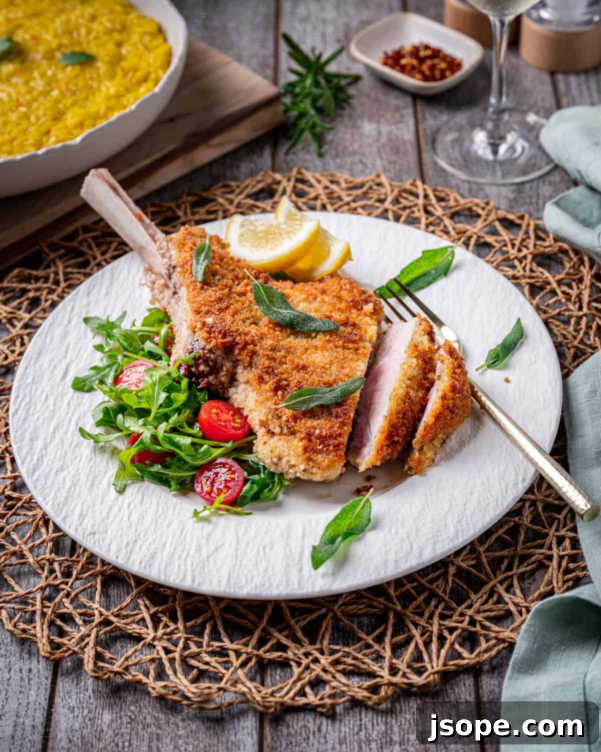 Raw bone-in veal chops seasoned and ready for breading for Veal Milanese