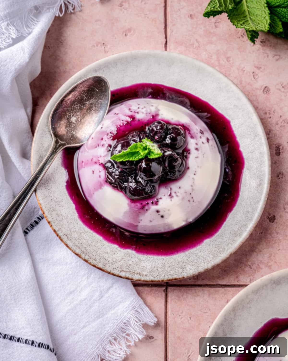 Panna Cotta Unmolded with Berry Compote and Mint