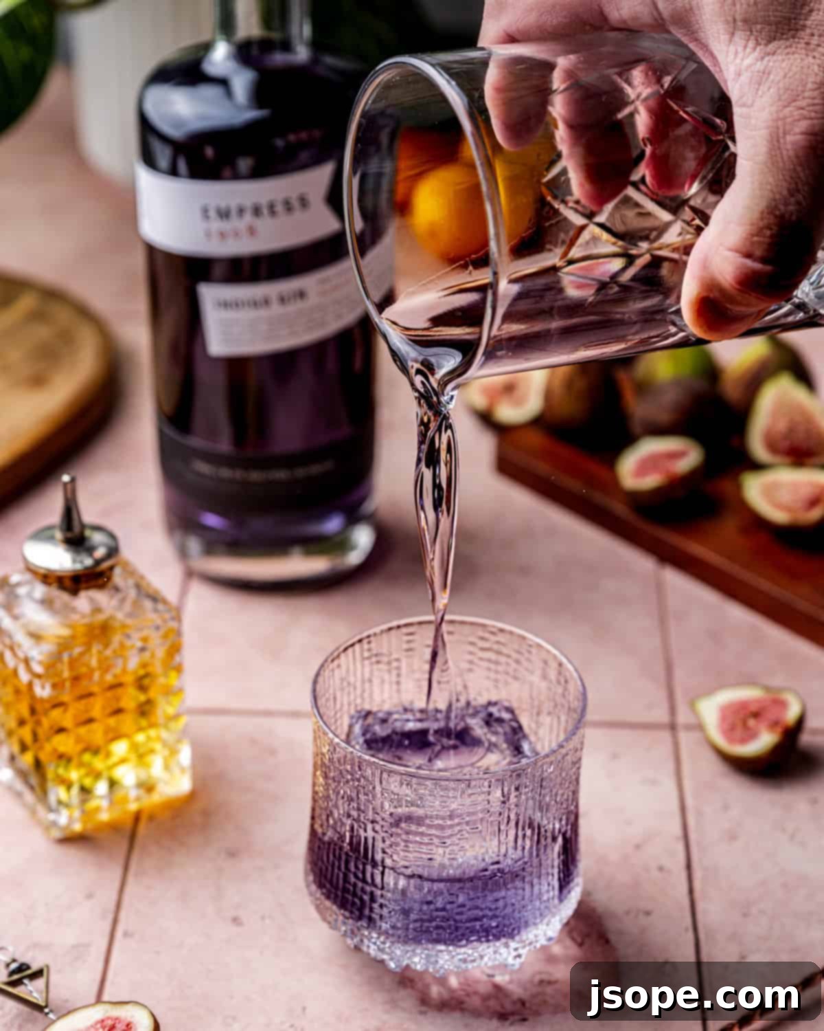 The process of making a fig cardamom gin old fashioned