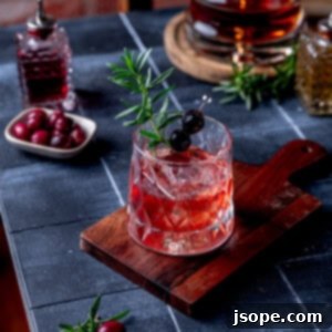 Spiced Cranberry Old Fashioned cocktail in a rocks glass.