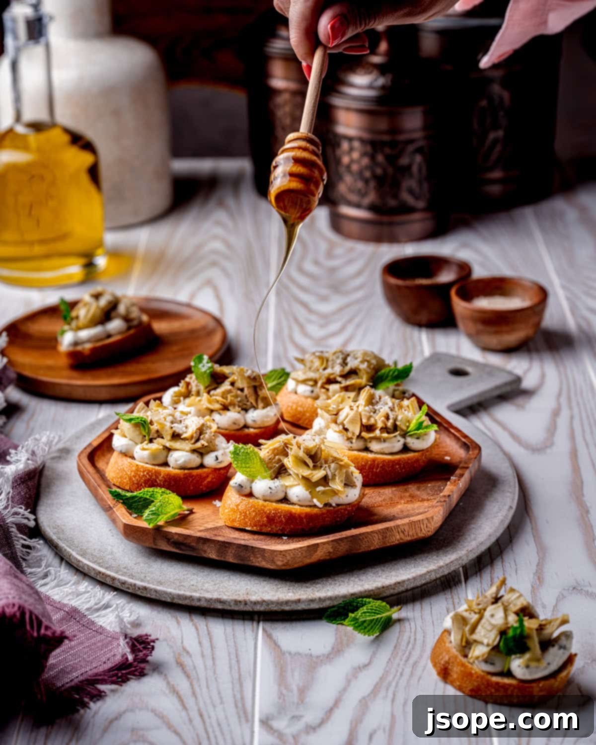 A serving platter filled with freshly assembled Marinated Artichoke Hearts Crostini, ready to be enjoyed.