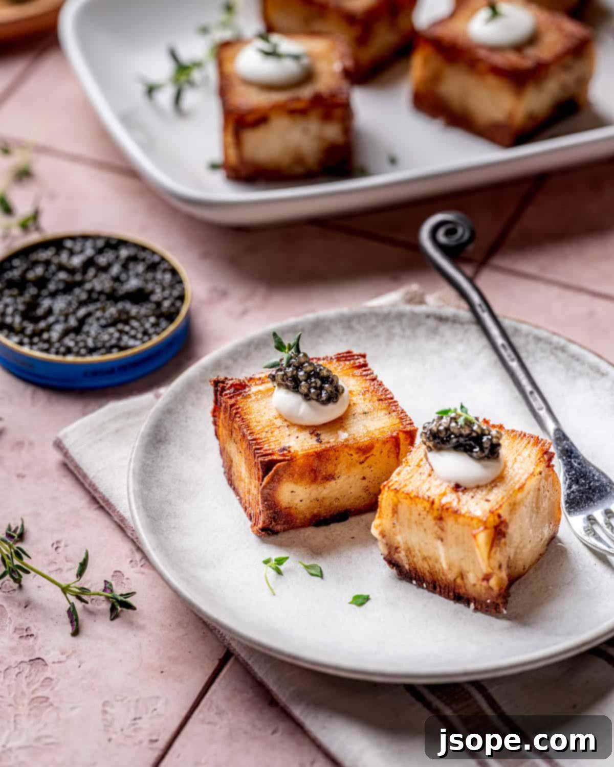 Garlic Parmesan Potato Pavé with Crème Fraîche and exquisite caviar topping