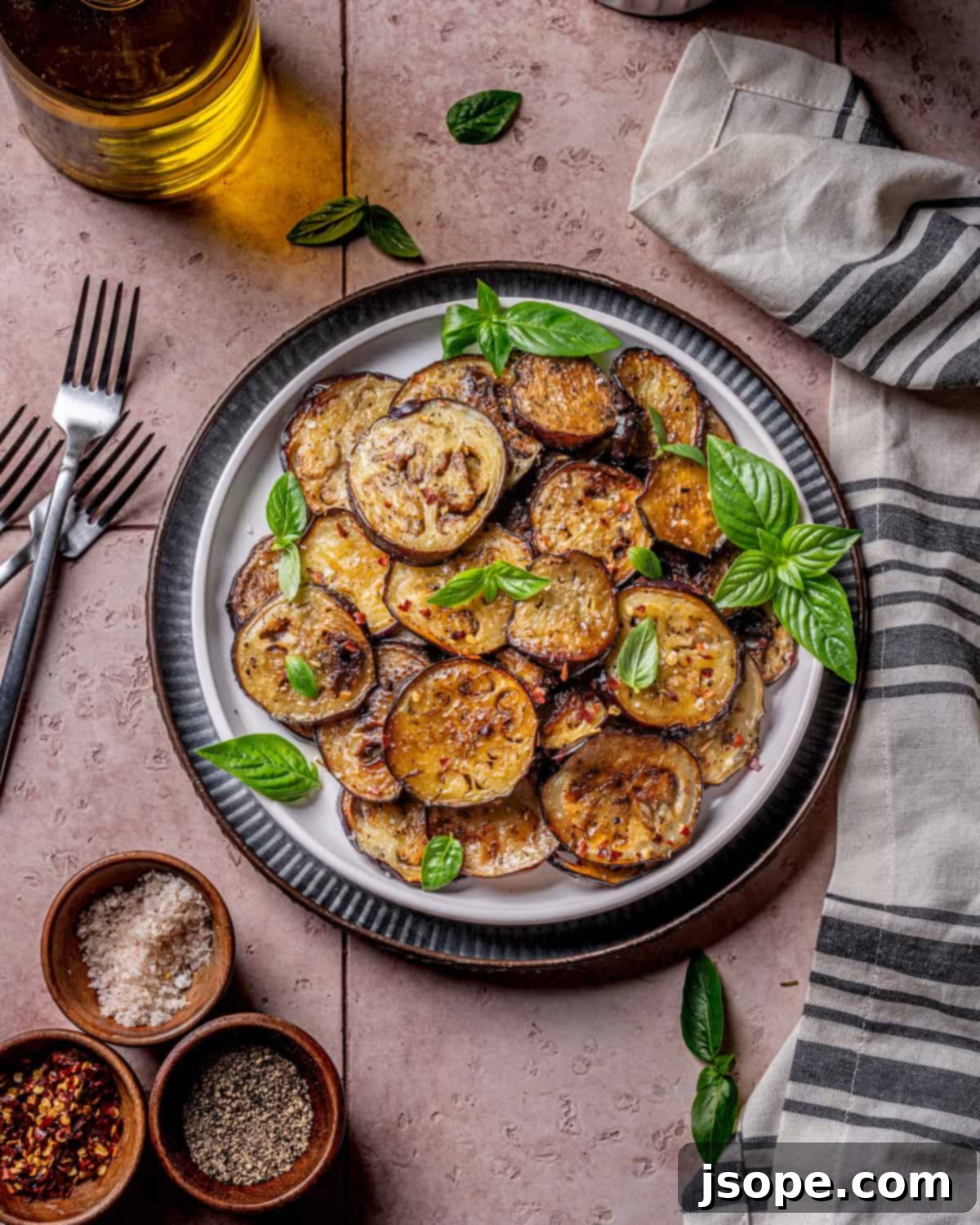 Sautéed Italian Eggplant in a bowl garnished with fresh basil