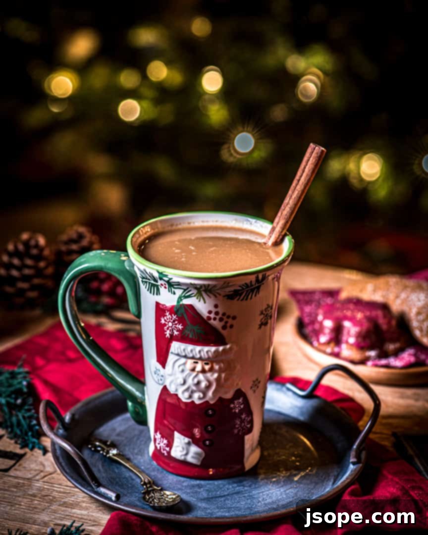 Hazelnut Hot Buttered Rum in a mug with a cinnamon stick garnish.