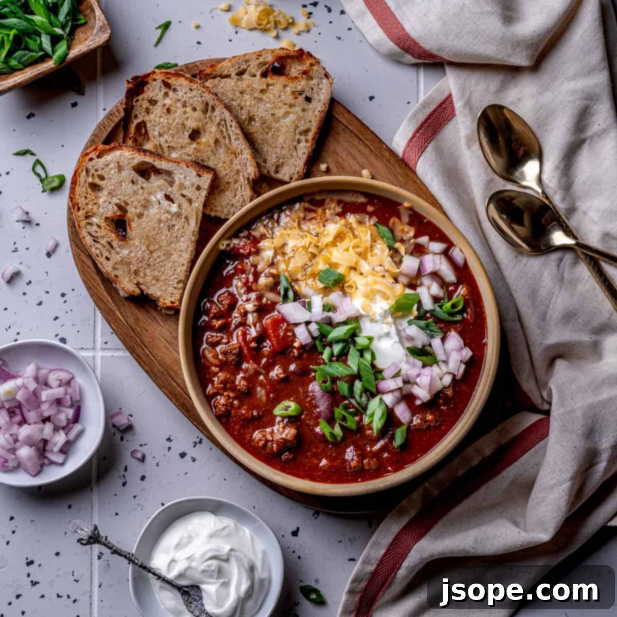 Hearty Chili with Kidney Beans in a large pot, garnished with fresh toppings