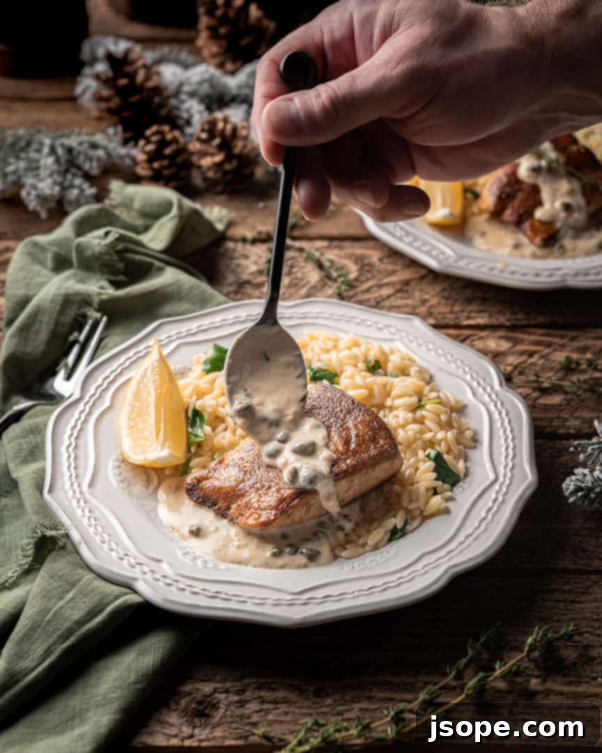 Close-up of seared Yellowtail on a plate with fresh lemon and caper sauce