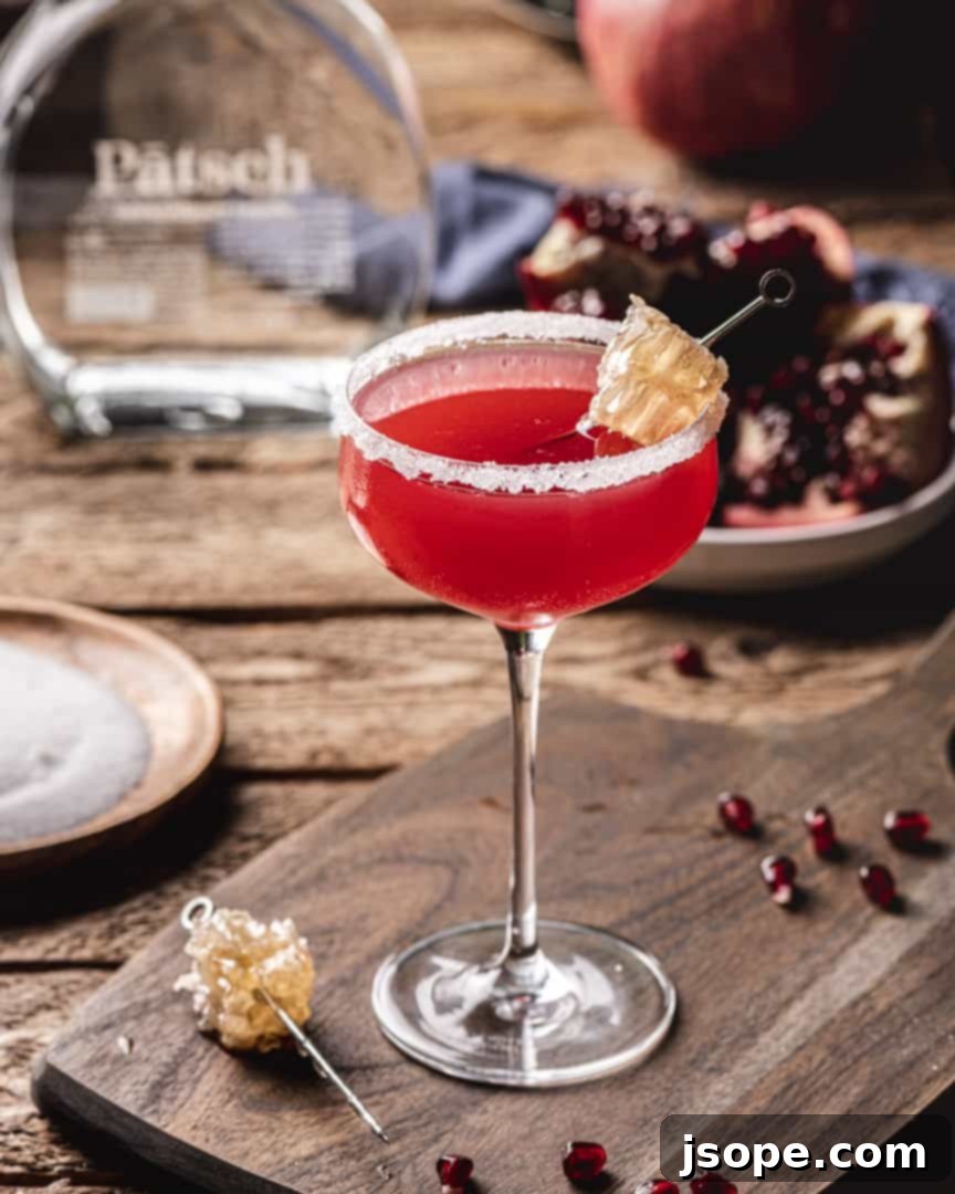 Close-up of the Tequila Bee Sting Cocktail with honeycomb garnish.