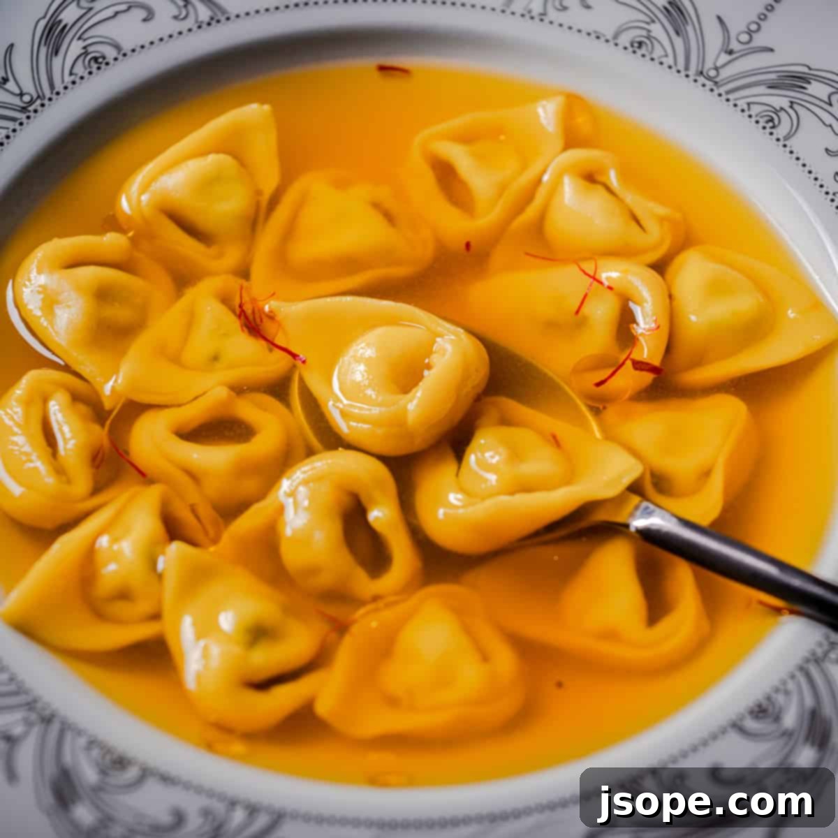 Exquisite Coriander Ricotta Tortellini in Saffron Brodo, a gourmet Italian pasta soup