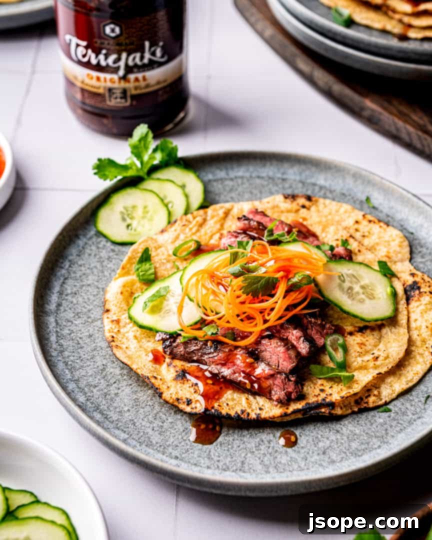 A vibrant platter of Teriyaki Steak Tacos, garnished with fresh toppings and ready for serving.