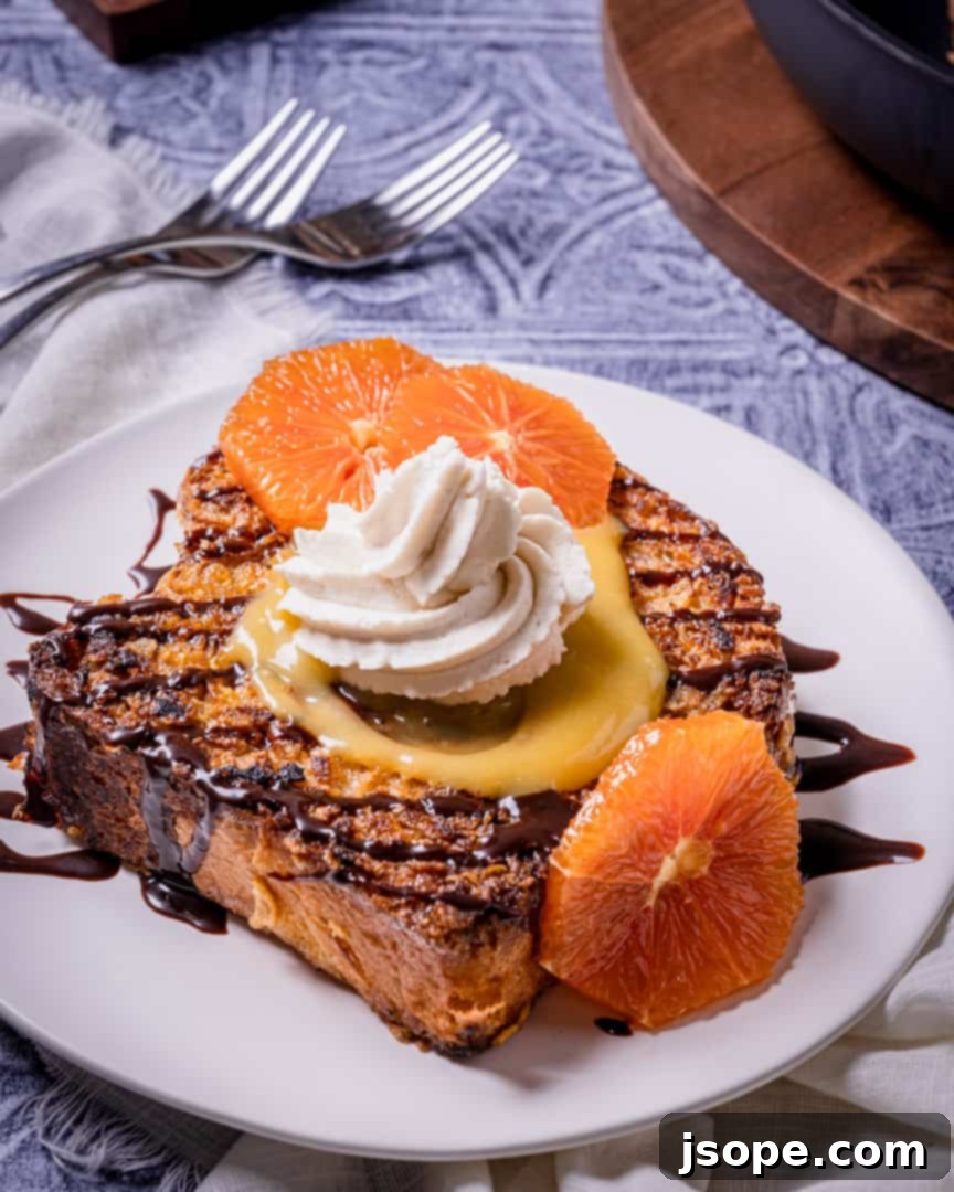 Crunchy Brioche French Toast with Orange Curd, Spiked Chocolate Sauce, and Mascarpone Cream, ready to be served.