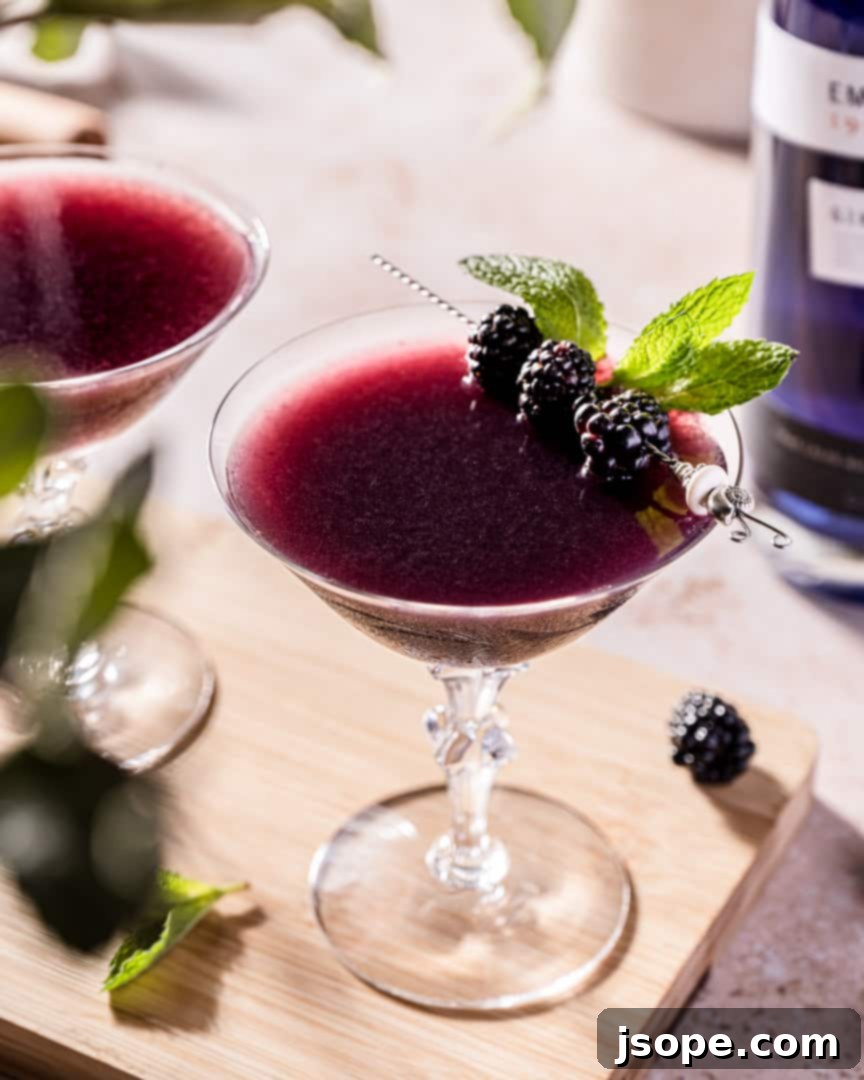 Blackberry Mint Gin Bliss 2 Muddled Blackberry and Mint Gin Cocktail, showcasing its vibrant purple color and mint garnish
