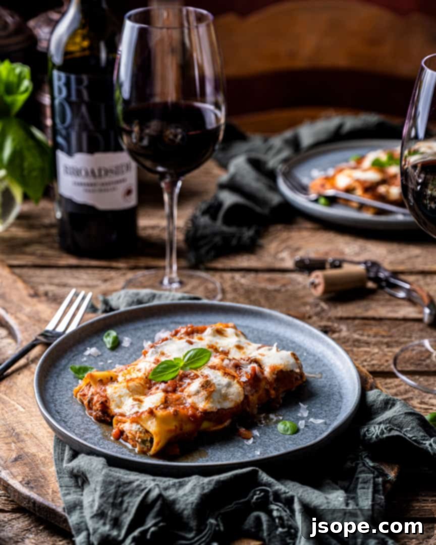 Platter of baked Ricotta and Spinach Cannelloni with Grandma's Sunday Sauce, garnished with fresh basil.