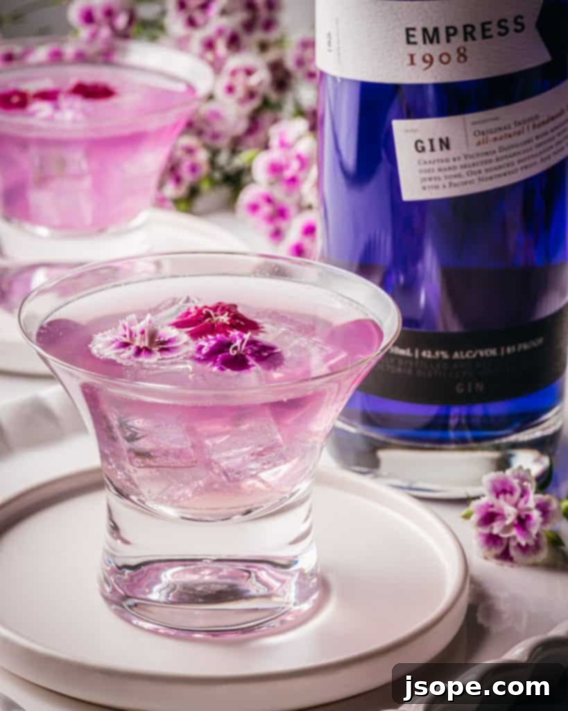 A vibrant Empress 1908 Gin cocktail in a glass, showcasing its unique color