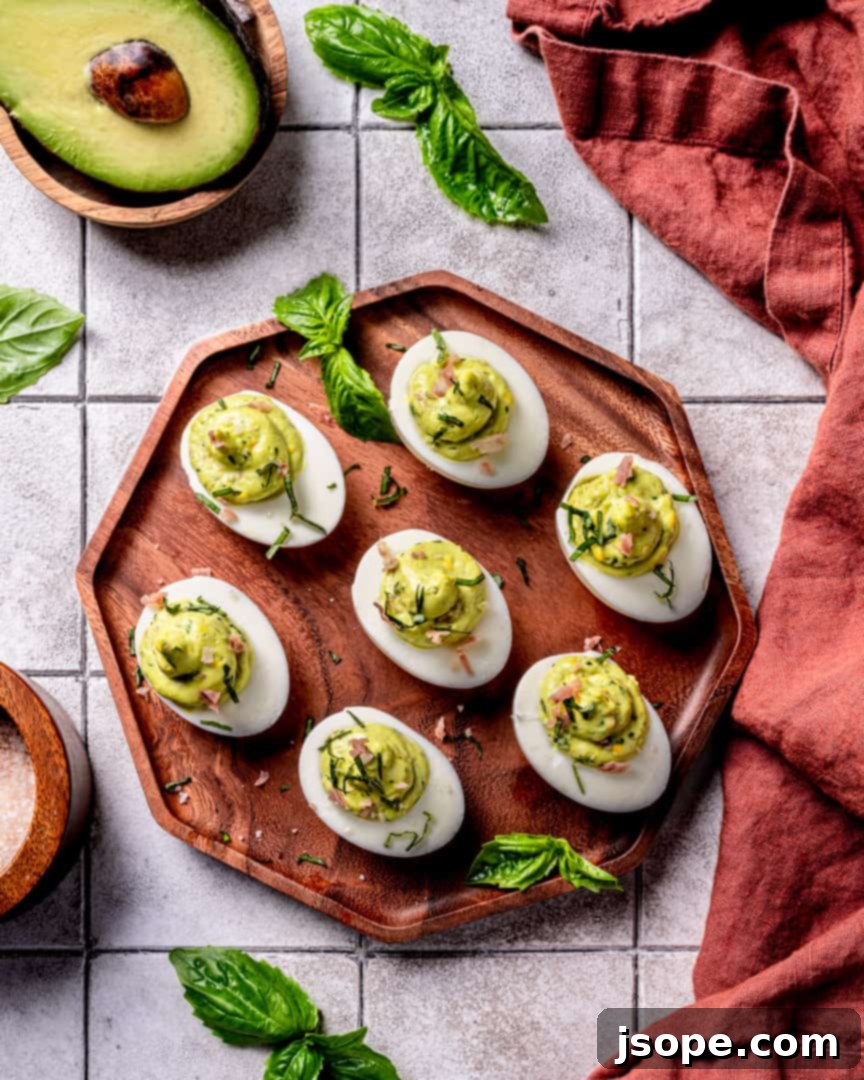 Close-up of Green Eggs and Ham Deviled Eggs showing the vibrant green filling and prosciutto garnish