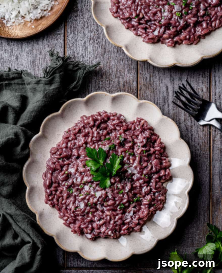A close-up shot of creamy Red Wine Parmesan Risotto garnished with fresh parsley.