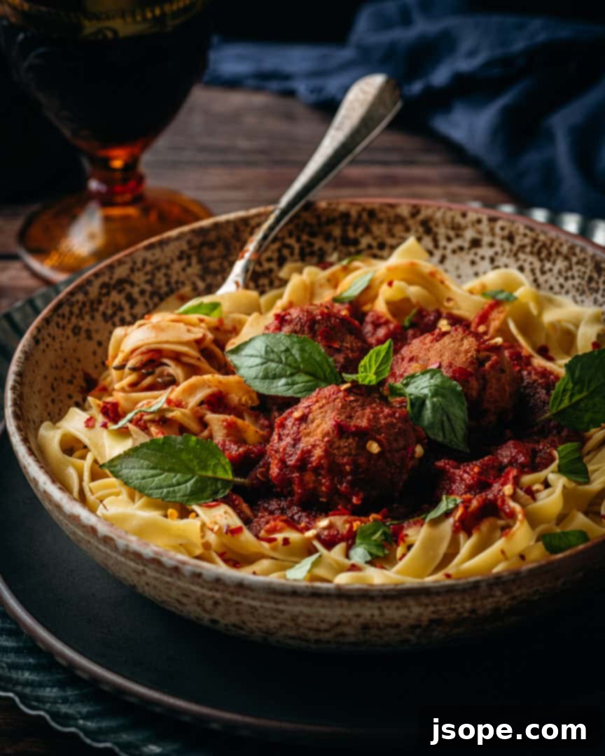 Marinara Sauce from Scratch with Fettuccini and Veal Meatballs: A bowl of fettuccini pasta topped with rich marinara sauce and tender veal meatballs, garnished with fresh herbs.